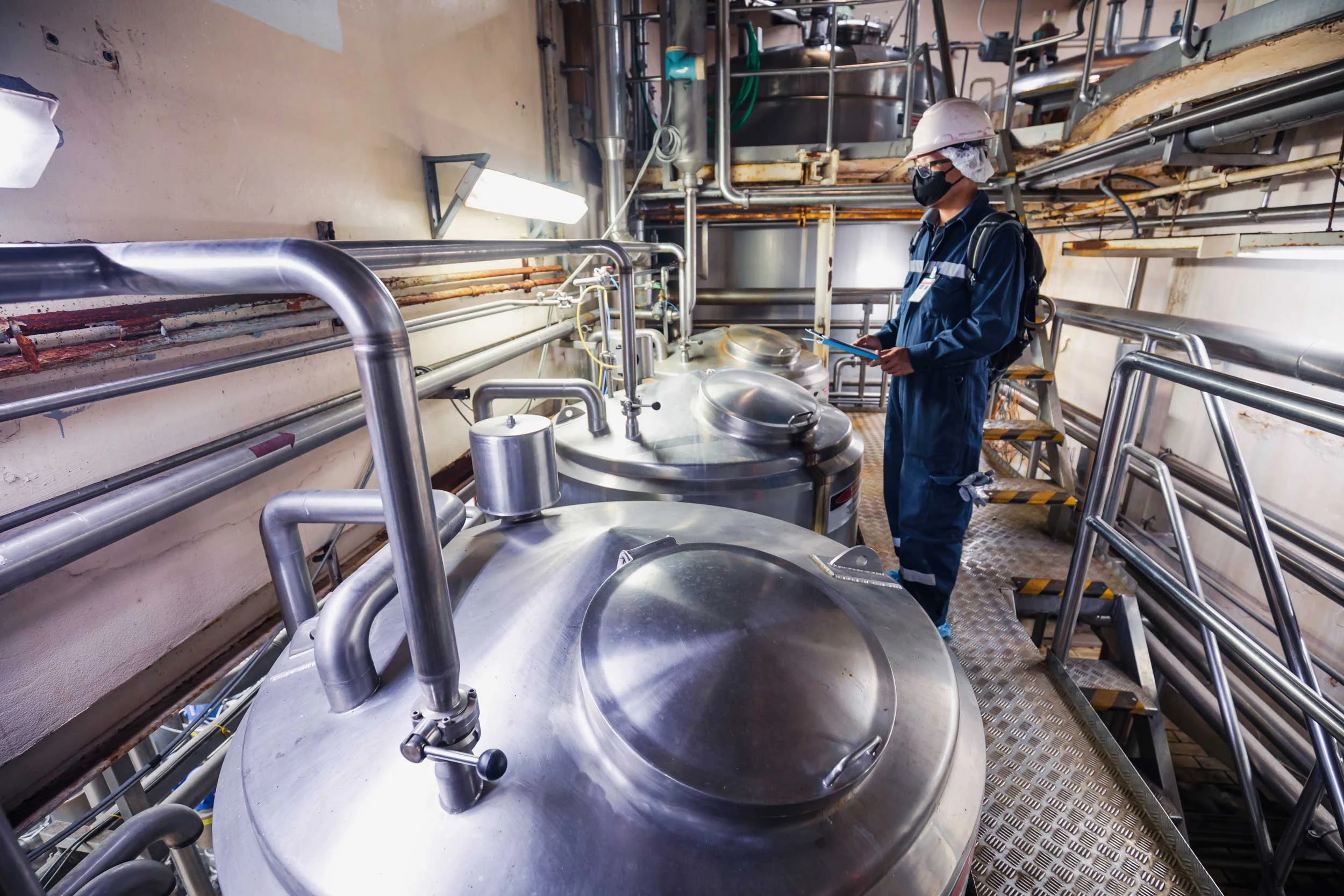 Stainless steel vessels and pipework in a processing plant